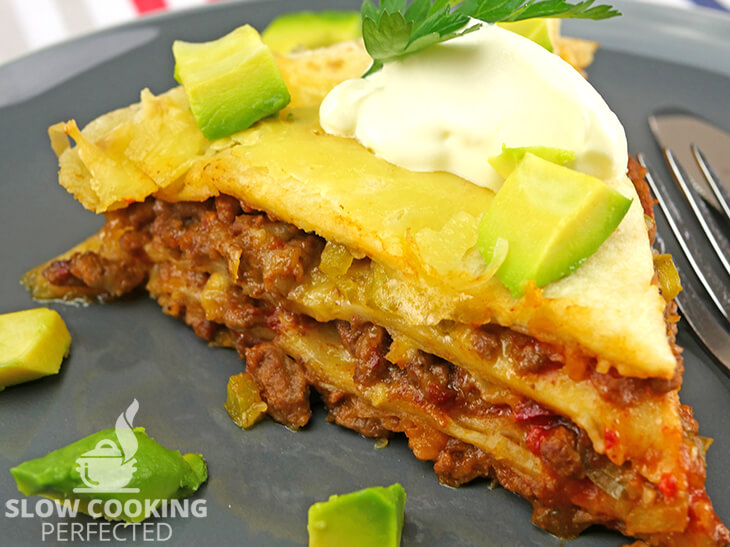 Layered beef enchiladas cooked in a slow cooker