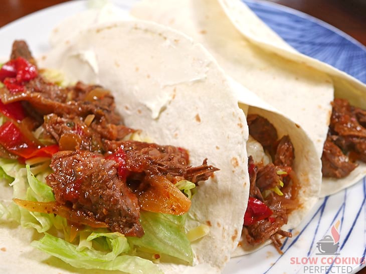 Slow-cooked shredded steak fajita mix inside a tortilla